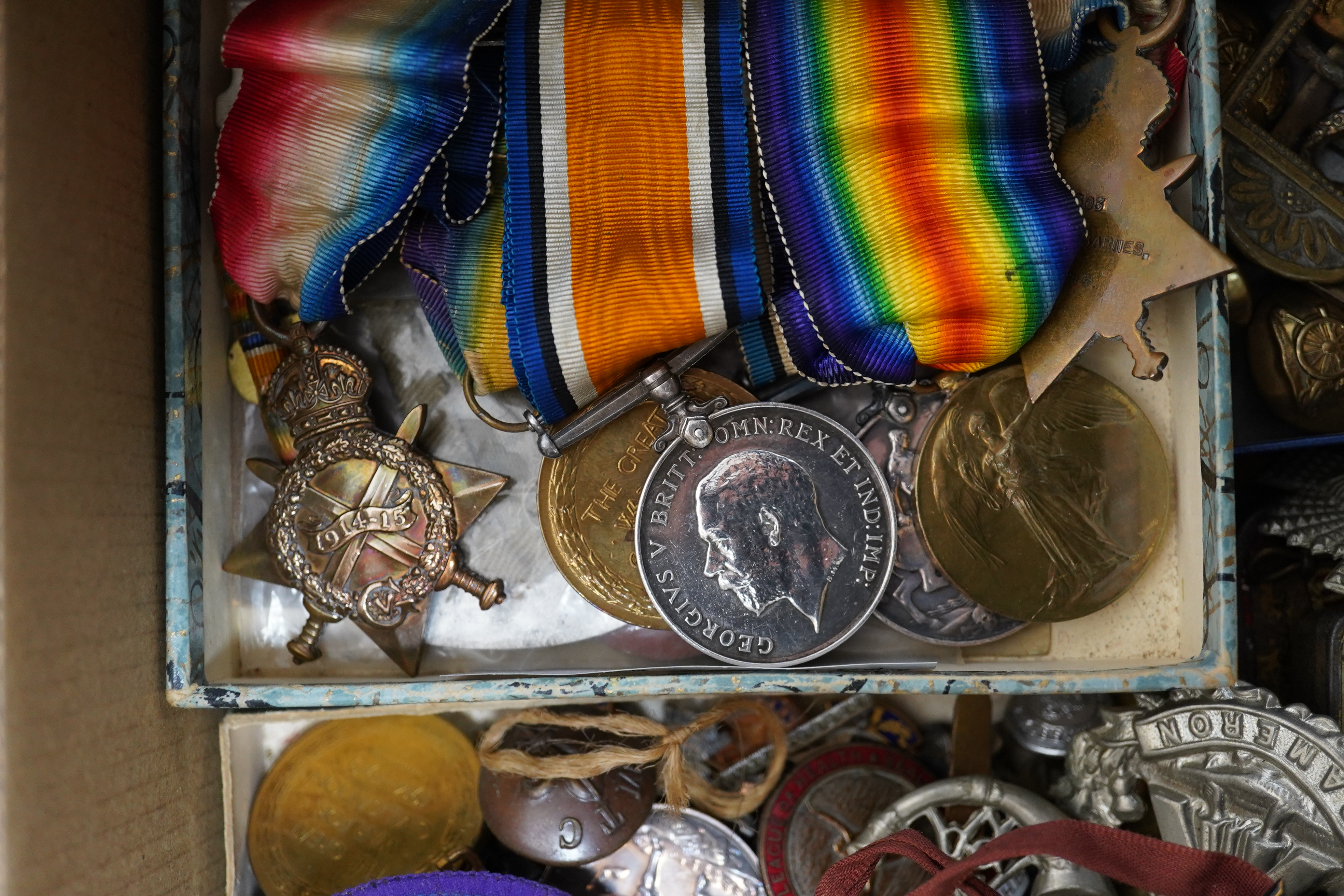 A collection of military medals, cap badges and buttons etc. including; a First World War Royal Navy Air Service cap badge, two WWI medal trios awarded to PTE. V.J.P. Barnes RIF. BRIG., and L.Cpl. W. Howard. NOTTS & DERB